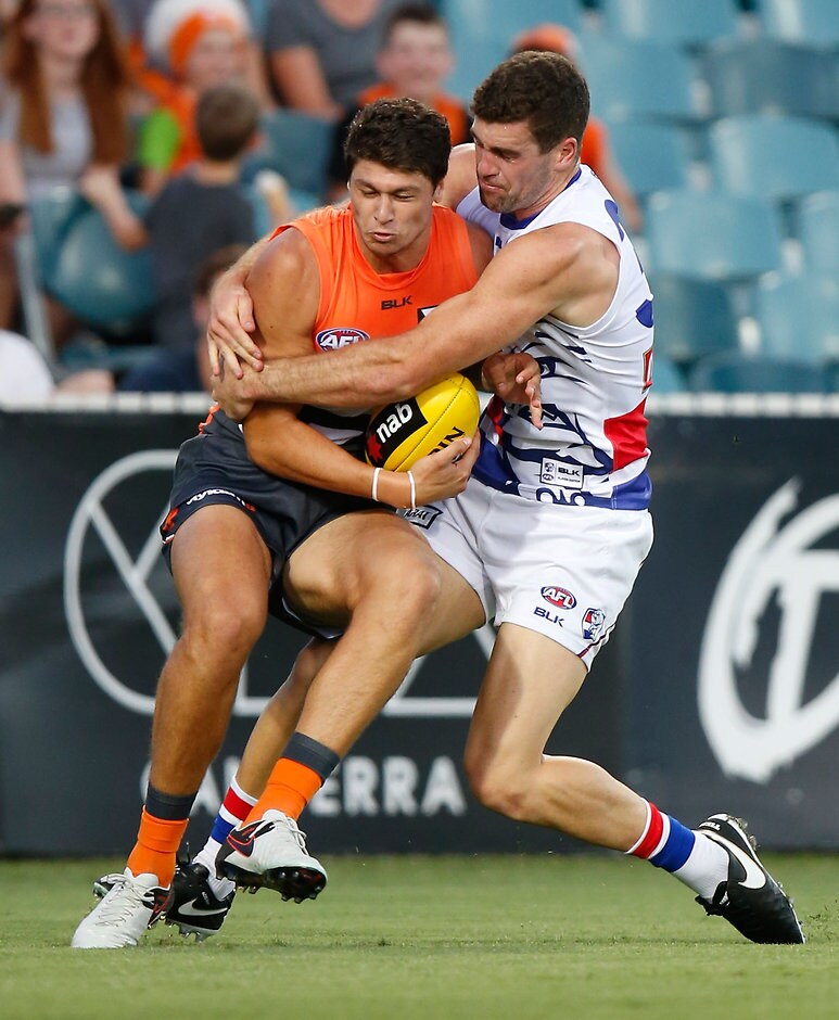 AFL 2016 NAB Challenge - GWS Giants v Western Bulldogs CANBERRA, AUSTRALIA - FEBRUARY 25: Jonathon Patton of the Giants is tackled by Kieran Collins of the Bulldogs during the 2016 NAB Challenge match between the GWS Giants and the Western Bulldogs at the Manuka Oval, Canberra on February 25, 2016. (Photo by Michael Willson/AFL Media)